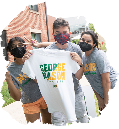 Students wearing masks and holding a Mason t-shirt